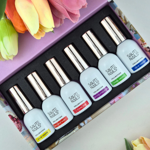 estuche contenedor con solapa abierta mostrando los 6 botes de esmaltes de la colección